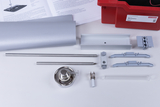 The image shows a collection of experimental materials including metal rods, brackets and a glass flask used for scientific experiments. In the background is an information leaflet that appears to provide instructions or details about the materials.