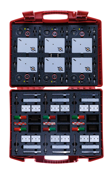 The picture shows a red case containing a variety of experimental materials. The equipment includes various measuring devices and accessories intended for use in education.