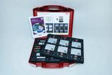 The picture shows a red suitcase equipped with various experimental materials for teaching electricity. Next to the materials is a manual entitled &quot;Electricity 2.0&quot;, which contains instructions and information for using the parts.