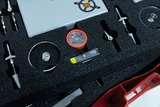 The picture shows a set of experimental supplies stored in a foam tray. The items shown include a compass, a spirit level and various measuring instruments.