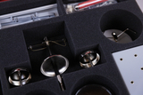 The image shows various experimental devices housed in a foam-padded compartment. These components appear to be designed for hands-on experiments in educational settings, possibly in physics or engineering classes.