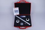 The picture shows a red suitcase containing materials for experiments on the human eye. Inside are two objects, a ruler, instructions and other small parts that can be used in class.