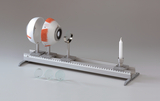 The picture shows an experimental device for studying light refraction and the human eye. Artificial eyes are arranged on a rail stand, next to them are various lenses and a candle as a light source.