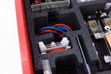 The picture shows a well-organized experiment set with various components stored in precisely fitting foam inserts. You can see colored cables, connectors and other technical components that are suitable for experimental applications in the educational sector.