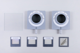 The picture shows two optical devices with round openings and scales, as well as several special foils with different lines/mm (600, 300 and 80). Also visible is a square piece of glass, presumably used in experiments.