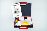 The picture shows a red plastic box with experimental materials for biology lessons. The box contains various tools and a manual with instructions for experimental projects.