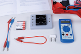 The picture shows a collection of experimental materials, including batteries, a multimeter and various connecting cables. This equipment is designed for educational purposes in science experiments.