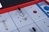 The picture shows an experiment station with several gray modules equipped with various electrical components. A digital multimeter is also included to take measurements and support the series of experiments.