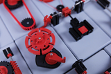 The picture shows an arrangement of experimental blocks in red and black that can be used for technical or physical experiments. The components appear to be parts of a modular system that simulates various mechanisms or machines.