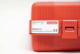 The picture shows a red plastic set labeled &quot;Electricity 2.0&quot; that is intended for experimental circuits on plug-in slots. It is part of a student set from Cornelsen Experimenta that was designed for the educational sector.
