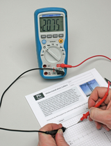 The image shows a digital multimeter showing a resistance of 2.075 kΩ. Next to it is a worksheet titled &quot;Resistance of a Conductor&quot; while a person connects two test leads to the conductor and takes notes.