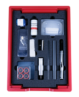 The picture shows an experiment kit arranged in a red box, with various materials such as iron powder, a magnet and several tubes. This set is designed for school experiments in the field of physics and magnetism.
