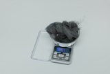 The picture shows a digital scale with a bowl of grey material on it. The scale shows a weight of 5.99 grams, which indicates that some experimentation is needed.
