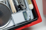 The image shows a selection of experiment materials including precision scales, measuring tools, spoons, chopsticks and cleaning brushes neatly arranged in a red container. These materials are ideal for school experiments and hands-on educational activities.