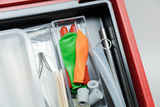 The picture shows a selection of experimental materials, including colorful balloons, tubes, and various small parts likely to be used for scientific experiments. The materials are neatly arranged in a storage box.