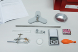 The image shows a selection of experiment materials, including a meter, a glass capillary, a candle, a balloon and other equipment. Also shown is an educational experiment manual explaining how to use the materials.