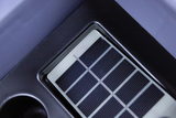 The picture shows a solar cell embedded in a gray holder. It consists of several parallel, black-colored strips that are used to use solar energy.