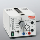 The picture shows an AC-DC power supply unit manufactured by the brand Cornelsen Experiminta. It is equipped with different voltage options from 2V to 12V and a rotary control to adjust the output voltage.