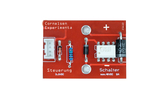 The picture shows a red circuit board that is part of an experiment kit, with various electronic components such as resistors and a switch. Labels on the board indicate the functionalities and voltage values of the components.