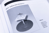 The image shows instructions for building a compass, presented in a monochrome diagram form. It lists the materials needed, including an air cushion plate and a magnetic needle, to realize the compass.
