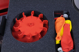 The picture shows a container with a red, star-shaped plastic topper and several colorful balloons in orange, yellow and red. The contents are neatly placed in a foam insert that can be used for educational experiments.