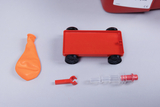 The picture shows various materials for experiments: an orange balloon, a red wagon model with black wheels and two other components that are probably used for experiments in physics or chemistry. These objects are part of a set for educational institutions.