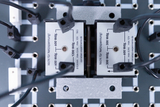 The picture shows an experiment board with several connections and two identification labels that provide information about resistors in watts. The labels are clearly marked with warnings that they must not be used for mains voltage.