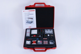 The picture shows an experiment set for electricity and magnetism, stored in a red case. It includes instructions and various materials and tools that can be used for practical experiments.