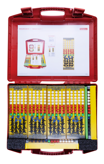 The picture shows a red plastic box filled with various modules for representing molecules. The box contains colorful balls and connectors that are used to visualize chemical structures in education.