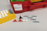 The picture shows a molecular construction kit consisting of different colored plastic balls and connecting elements used to learn about molecular structures. The kit is red and bears the label of the supplier, Cornelsen, and is intended for educational use.