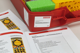 The picture shows a red box with the title &quot;Molecular Construction Kits 1&quot; from Cornelsen, which contains experimental materials for educational purposes. Next to the box are two teaching booklets that explain the contents and applications of the molecular construction kits.
