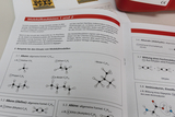 The image shows a page from a molecular modeling textbook that presents examples of chemical compounds such as alkanes and alkenes. Various molecular structures and their general formulas are shown to illustrate the use of molecular models in teaching.