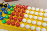 The image shows a set of colorful plastic balls and connectors on a yellow base, used to represent molecular structures. The different colors represent different atoms and allow for vivid chemical experiments in educational settings.
