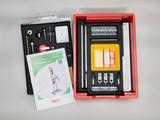 The picture shows a mechanics experiment kit for students organized in a red box. It contains various physics tools and a manual called &quot;Mechanics 2.0&quot; for teaching purposes.