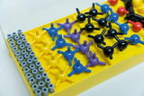 The picture shows a set of colorful plastic modules that can be used to illustrate chemical molecules. The pieces are arranged on a yellow board, with different colors representing the different atoms.
