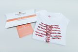 The image shows a white T-shirt with a striking, colorful print depicting a stylized skeleton. This includes packaging with the &quot;Body Planet&quot; logo and the slogan &quot;A fun way to learn!&quot;, indicating an educational approach.