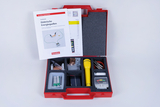 The picture shows a red suitcase filled with experimental materials on the topic of electrical energy sources. It contains batteries, a solar cell, cables, a measuring device and instructions describing how to use the materials.