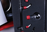 The image shows various transparent laboratory equipment stored in a custom-fit foam tray. These items appear to be designed for chemical experiments, including glass containers and connectors with red caps.
