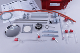 The image shows a set of various laboratory equipment and materials intended for educational experimentation purposes. This includes glassware, connectors and instructions for conducting experiments, presumably on distillation.