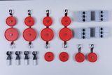 The picture shows an arrangement of red pulleys and gray blocks used in experimental supplies. These components are probably intended for physics experiments to analyze forces and motions.