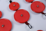 The picture shows several red experimental devices connected by metal clips. They are probably part of a scientific set for educational use, for example for physics experiments.
