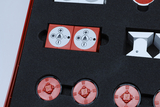 The image shows various experimental components in a red foam tray. Red and white components with symbolic labels are visible, likely used for physics experiments in educational settings.