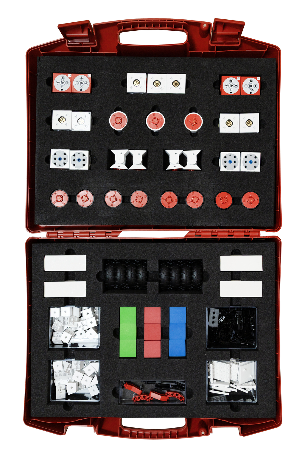 The image shows a red suitcase filled with various experimental materials, including balls, wheels, building blocks, and other components for educational use. The sorted pieces are arranged in a foam insert for easy organization.