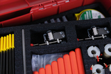 The picture shows a red box containing various experimental materials, including yellow and red rods and mechanical components. The materials are arranged in foam padding to ensure safe transport and neat storage.