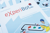 The image shows the cover of a series of teaching materials called &quot;eXperiBot&quot; by Cornelsen Experimenta, which deals with a smart factory. It shows a figure interacting with a vehicle and various shapes in an experimental environment.