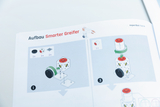 The image shows instructions for building a &quot;Smart Gripper&quot; in which various components such as wheels and cubes are shown. Step-by-step illustrations show how the components are connected to each other.