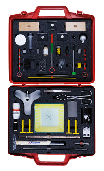 The picture shows a red toolbox filled with various experimental materials. The box contains measuring instruments, chemicals, glasses and various utensils that can be used for scientific experiments.