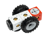 The picture shows a modular robot with large tires, which is made up of several colored cubes. The cubes are equipped with various electronics and enable experimental learning in the field of robotics and programming.