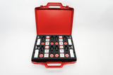 The picture shows an opened red suitcase filled with various black foam experimental components. The components include a variety of red and silver components that can be used for educational science experiments.