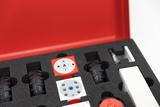 The picture shows a red box with a foam insert that contains various components for experiments, including wheels, special components and an electronic control system. These materials are designed for use in the German education system to promote hands-on learning.